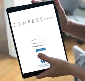 hands holding mobile device, showing COMPASS mobile sign in page