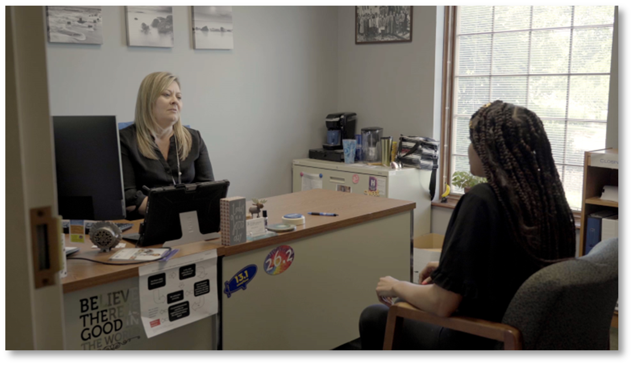 Two women meeting at an office desk