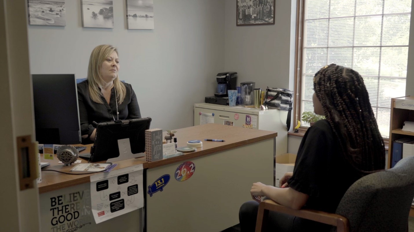 Two women meeting at an office desk